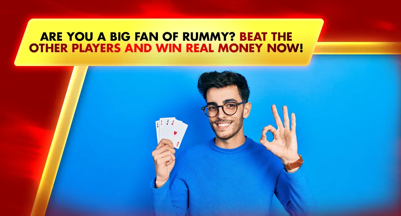 man in blue holding rummy cards